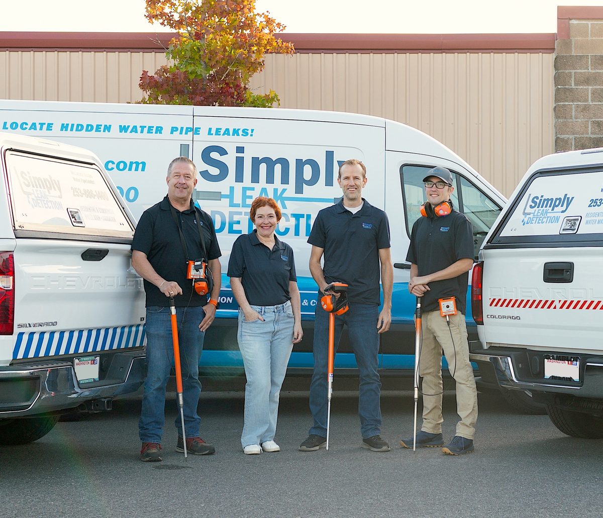 The Simply Leak Detection team with their leak detection equipment and service vehicles